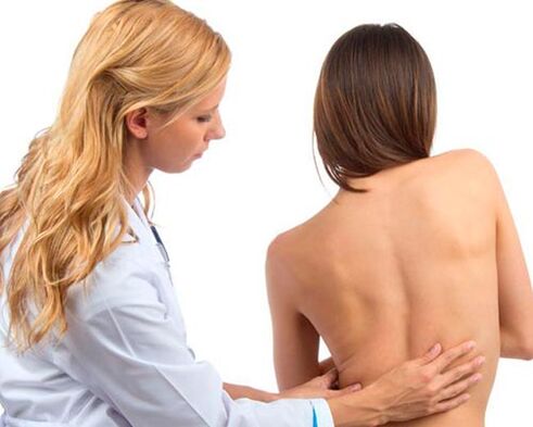 doctor examines back for lower back pain
